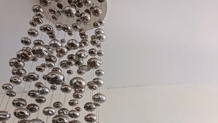 A large silver chandelier with many small silver balls hanging from it