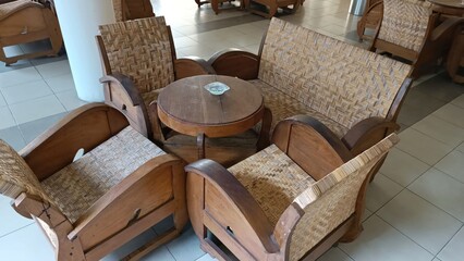 A wooden chair and table are arranged in a room