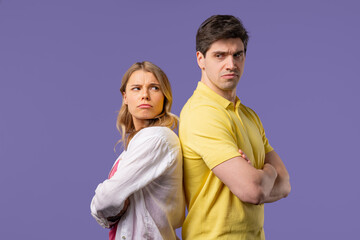Young offended couple after quarreling, standing back. Selfishness, resentment