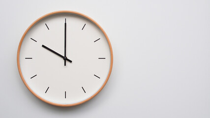 Minimalist wooden Wall Clock on White Wooden Surface with Space for Text – Time Set at 10.00,...
