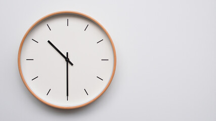 Minimalist wooden Wall Clock on White Wooden Surface with Space for Text – Time Set at 10.30,...