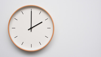 Minimalist wooden Wall Clock on White Wooden Surface with Space for Text – Time Set at 14.00/02.00