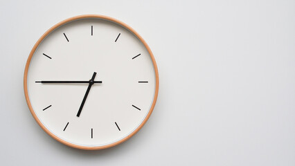 Minimalist wooden Wall Clock on White Wooden Surface with Space for Text – Time Set at 18.45/06.45