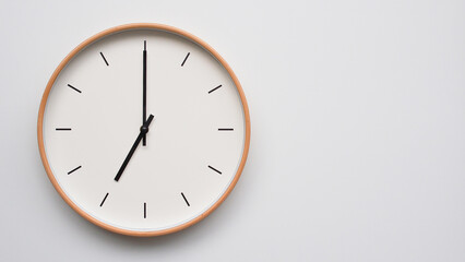 Minimalist wooden Wall Clock on White Wooden Surface with Space for Text – Time Set at 19.00/07.00