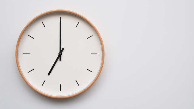 Minimalist wooden Wall Clock on White Wooden Surface with Space for Text &ndash; Time Set at 19.00/07.00