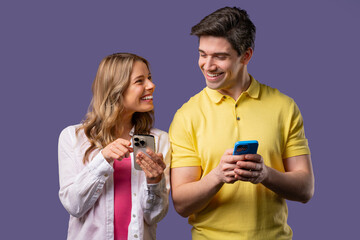 Young couple using mobile device. Woman man watching, laughing with smartphone