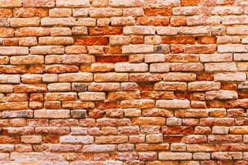 Old red brick wall background in Venice, Italy.