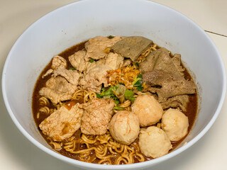 A captivating image of a bowl of noodles, beautifully presented with a variety of fresh ingredients and garnishes. The rich textures and vibrant colors make it an enticing visual for food enthusiasts