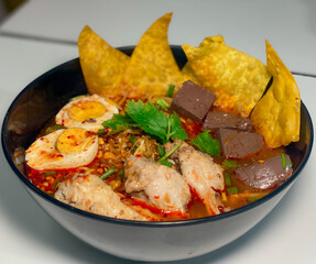 A captivating image of a bowl of noodles, beautifully presented with a variety of fresh ingredients and garnishes. The rich textures and vibrant colors make it an enticing visual for food enthusiasts