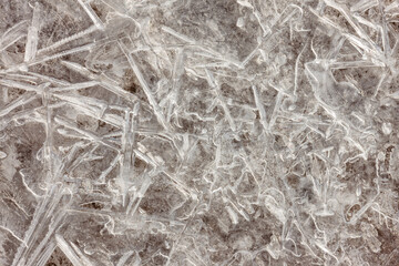 An overhead view of ice crystals from Lake Michigan water frozen over a small impression on the beach at Harrington Beach State Park, Belgium, Wisconsin in early January