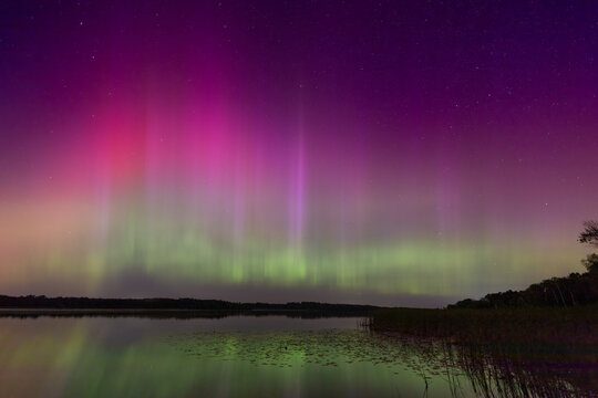 Mesmerizing Aurora Borealis Over Typo Lake, Stacy, Minnesota - A Celestial Dance of Colors Reflecting on Tranquil Waters with Pillars of Light in Columns and Ribbons