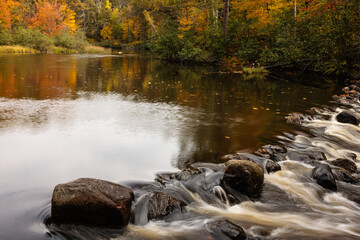 The Manitowish River flows toward the small rapids in early October near Boulder Junction, Wisconsin