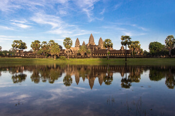 Naklejka premium ANGKOR WAT, SIEM REAP, CAMBODIA - NOVEMBER 16, 2016: Angkor Wat in Cambodia is a majestic ancient temple complex, known for its stunning sunrise views, intricate carvings, and rich history.