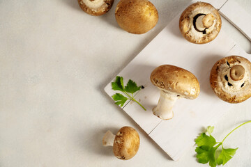 Raw champignon on a cutting board, button mushrooms. Vegan protein.