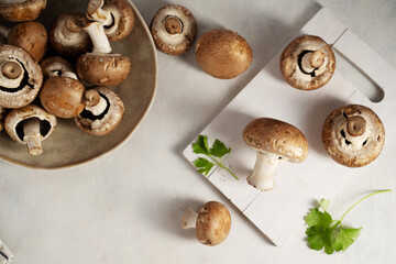 Raw champignon on bright background, button mushrooms. Vegan protein.
