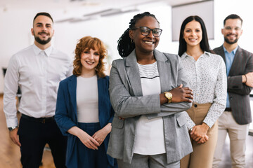 Portrait of young CEO African American businesswoman standing with her arms crossed in front of her...