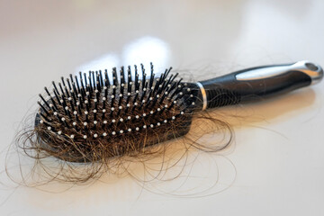 extrem hair loss with the brush on a white background