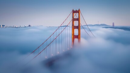 Fototapeta premium The Golden Gate Bridge shrouded in fog, its towering orange towers emerging from the mist, creating a mysterious and dramatic scene