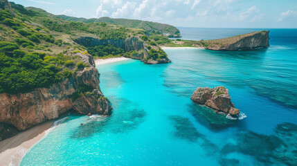 Fototapeta premium A beautiful beach with a clear blue ocean and green mountains in the background