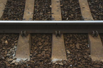 Railway rail, sleepers across, at one of the stations. Railway tracks
