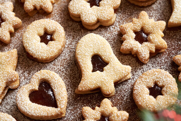 Closeup of homemade Linzer Christmas cookies filled with jam and dusted with sugar