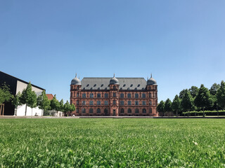 A large building with a green lawn in front of it