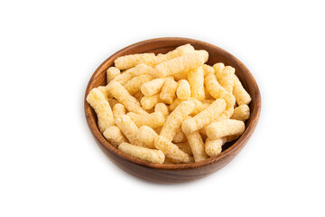 Corn flakes sticks with caramel in wooden bowl isolated on white, side view, close up.