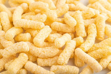 Corn flakes sticks with caramel isolated on white, top view, close up.