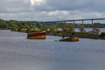 A shipwreck on the banks of the River Clyde in Bowling, Scotland, UK