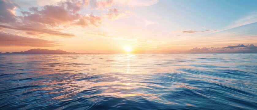  The sun sets over the ocean, painting a small island mid-frame in hues of gold, while scattered clouds tinge the sky pink and orange