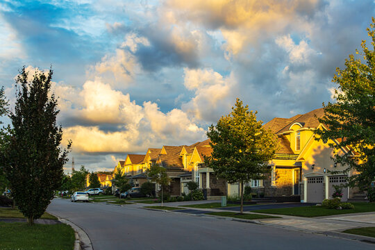 Suburban houses in a Ancaster street, Ontario. Ancaster is a community located on the Niagara Escarpment that amalgamated with the city of Hamilton, Ontario, Canada in 2001.
