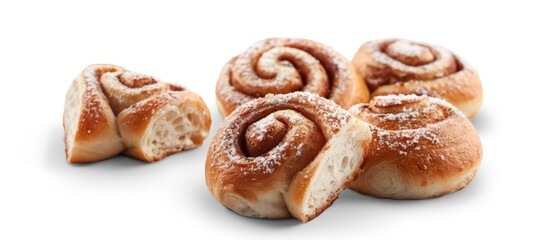  A collection of cinnamon buns atop a pristine white counter, dusted with powdered sugar