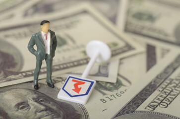 The juxtaposition of the US dollar bill, a symbol of wealth and stability, with the downward arrow suggests economic decline or financial instability.