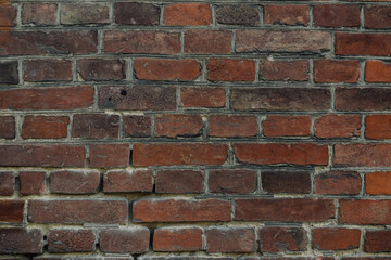 A brick wall with a few missing bricks