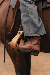Western horse riding boots in stirrups