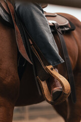 Western horse riding boots in stirrups