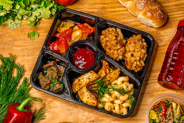 Lunch to go in a container on a wooden table background