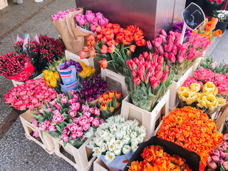 A colorful display of flowers in wooden crates
