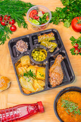 Lunch to go in a container on a wooden table background