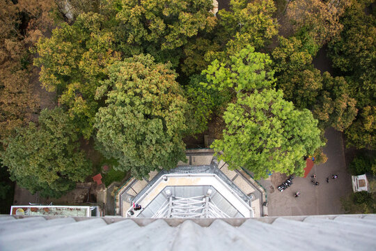 PETŘÍNSKÁ ROZHLEDNA, PRAGUE, CZECHIA - SEPTEMBER 12, 2014: View of the base of The Petrin Tower, from the top. The 63m-tall lookout tower in Prague is surrounded by tress and gardens.