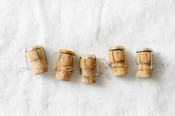 Set of wine cork from sparkling wine on white fur background, copy space, bottle stoppers top view...