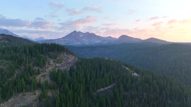 A summer sunrise illuminates the landscape around Three Sisters mountains, Oregon. These mountains and their surrounding forests, near Bend, provide exceptional hiking, biking, climbing, and camping.