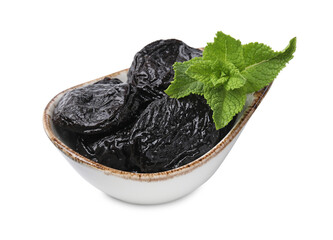 Tasty dried plums (prunes) and mint leaves on white background