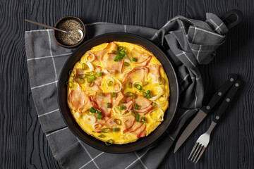 deli ham onion omelette on skillet, top view