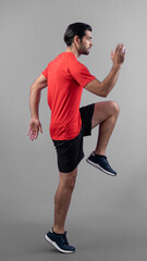 Full body length gaiety shot athletic and sporty young man fitness running cardio exercise posture on isolated background. Healthy active and body care lifestyle.