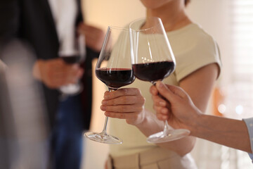 Friends with glasses of red wine, selective focus