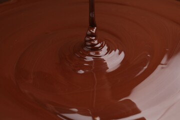 Closeup view of pouring delicious melted chocolate