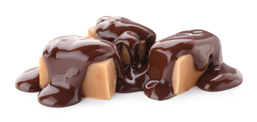 Delicious caramel candies with melted chocolate isolated on white