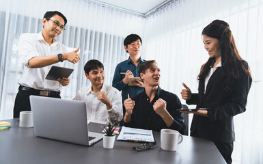 Excited and happy office worker employee celebrate after make successful strategic business marketing planning. Teamwork and positive attitude create productive and supportive workplace. Prudent