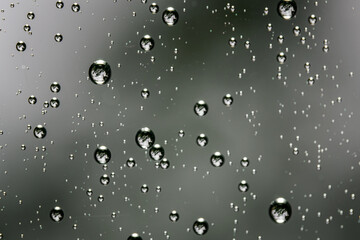 Raindrops on glass in detail.